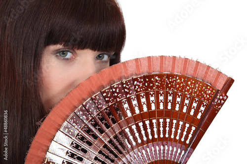 Photo: Woman holding hand fan Woman holding hand fan