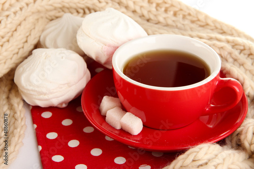 Photo: cup of tea with scarf isolated on white cup of tea with scarf isolated on white