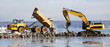 bulldozer dredging with truck delivering rocks