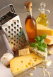 Assortment of cheeses and olive oil on table
