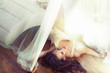 Photo: Sexy brunette lying on the wooden floor Sexy brunette lying on the wooden floor