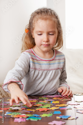 Photo: Girl playing puzzle Girl playing puzzle