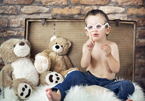 Photo: Small cute kid with teddybears Small cute kid with teddybears