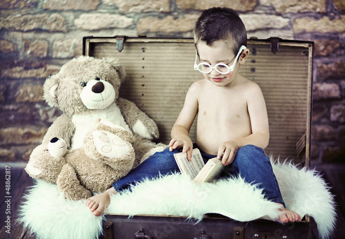 Photo: Cute child trying to read Cute child trying to read