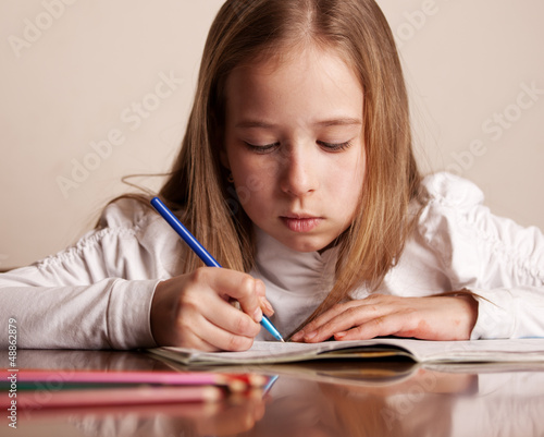 Photo: Girl doing homework Girl doing homework