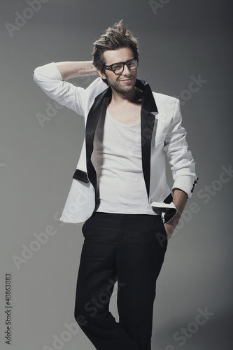 Photo: Handsome man casually leaning against the wall Handsome man casually leaning against the wall