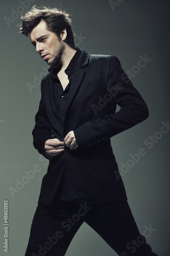 Photo: Young confident man wearing suit Young confident man wearing suit
