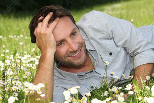 Photo: Man lying on grass Man lying on grass