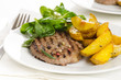 Photo: Beef burger with the roasted potato, side salad and spices on wh Beef burger with the roasted potato, side salad and spices on wh
