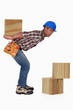 Handyman carrying wooden blocks on his back