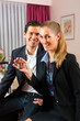 Young couple sitting on bed in hotel room