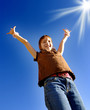 Young Girl with Arms Raised Towards Sunshine