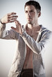 Young attractive man making Thai-chi movements