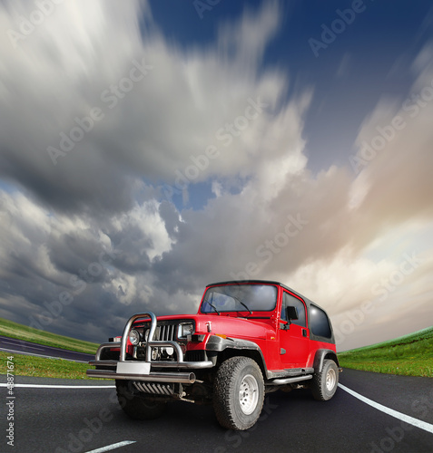 Photo: All-wheel drive car at the deserted highway All-wheel drive car at the deserted highway