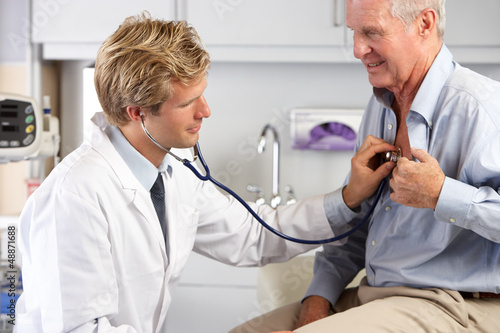Photo: Doctor Listening To Male Patient's Chest Doctor Listening To Male Patient's Chest