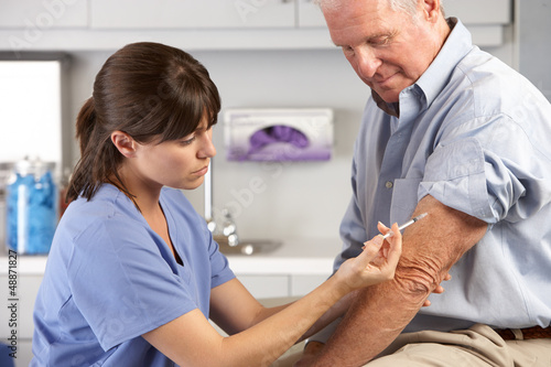 Photo: Doctor Giving Male Patient Injection Doctor Giving Male Patient Injection