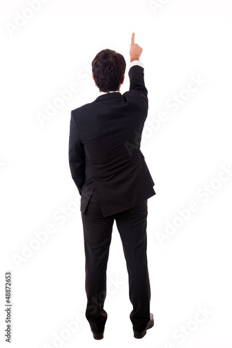 Photo: Young male businessman pointing at copyspace over white backgrou Young male businessman pointing at copyspace over white backgrou