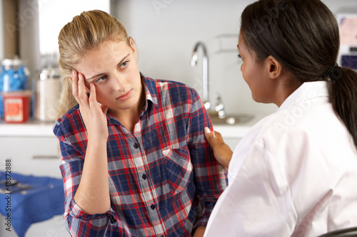 Photo: Teenage Girl Visits Doctor's Office Suffering With Depression Teenage Girl Visits Doctor's Office Suffering With Depression