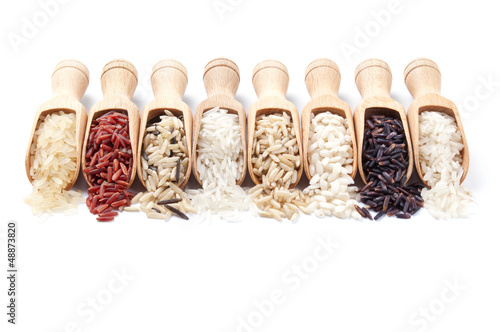 Photo: Wooden scoops with different rice types scattered from them Wooden scoops with different rice types scattered from them