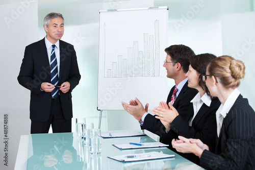 Photo: Colleagues clapping after a staff presentation Colleagues clapping after a staff presentation