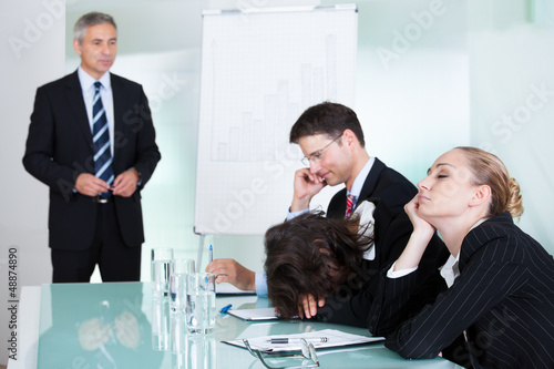 Photo: Bored businesswoman sleeping in a meeting Bored businesswoman sleeping in a meeting