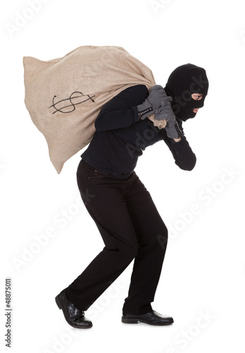 Photo: Thief carrying a large bag of money Thief carrying a large bag of money
