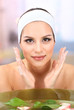 Young woman washing her face. Conceptual photo: make-up remover