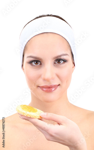 Photo: Young woman cleansing her face with scrub, isolated on white Young woman cleansing her face with scrub, isolated on white