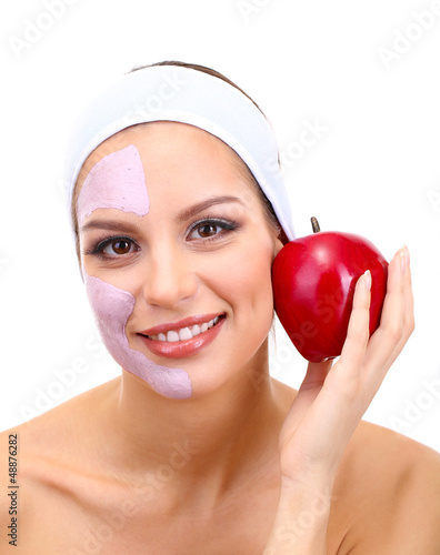 Photo: Young woman with clay facial mask, isolated on white Young woman with clay facial mask, isolated on white