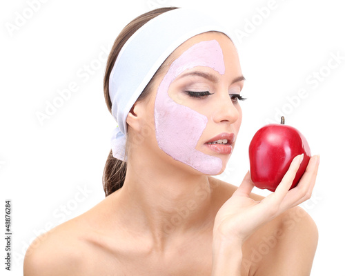 Photo: Young woman with clay facial mask, isolated on white Young woman with clay facial mask, isolated on white