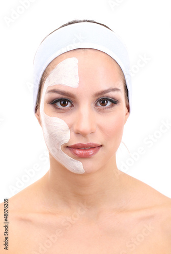 Photo: Young woman with clay facial mask, isolated on white Young woman with clay facial mask, isolated on white