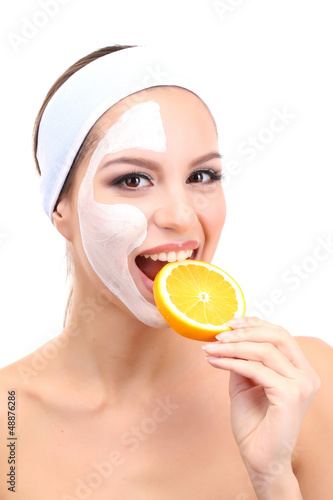 Photo: Young woman with clay facial mask, isolated on white Young woman with clay facial mask, isolated on white