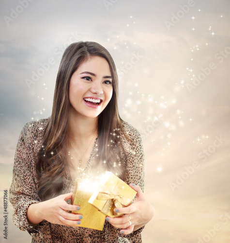 Photo: Girl Opening a Shinning Giftbox Girl Opening a Shinning Giftbox