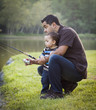 Happy Young Ethnic Father and Son Fishing