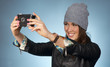 Hip Woman Snaps a Picture of Herself with Vintage Camera