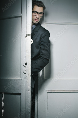 Photo: Good-looking man behind the door Good-looking man behind the door