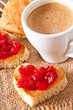 Photo: heart-shaped toast with jam and a cup of coffee heart-shaped toast with jam and a cup of coffee