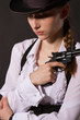 Photo: Portrait of beautiful young woman with a gun. Portrait of beautiful young woman with a gun.