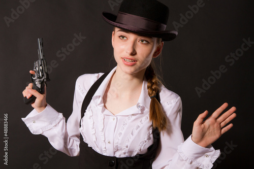 Photo: Portrait of beautiful young woman with a gun. Portrait of beautiful young woman with a gun.