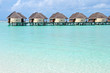 over water bungalows in blue ocean lagoon