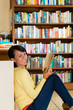 Young Girl in library reading book