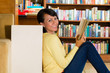 Young Girl in library reading book