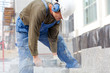Worker makes a horizontal cut with an electric hand saw