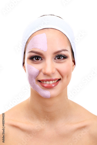 Photo: Young woman with clay facial mask, isolated on white Young woman with clay facial mask, isolated on white