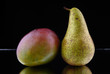 Photo: apple and pear on black background apple and pear on black background