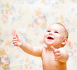 Laughing baby hands up