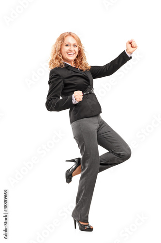 Photo: Full length portrait of a woman gesturing happiness Full length portrait of a woman gesturing happiness