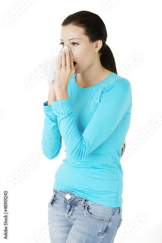 Photo: Young woman with tissue - sneezing Young woman with tissue - sneezing