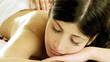 Beautiful woman getting back massage during vacation