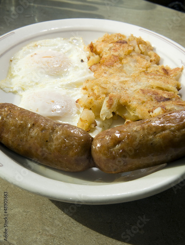 Photo: fried eggs over easy pork sausages home fried potatoes breakfast fried eggs over easy pork sausages home fried potatoes breakfast